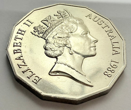 Silver coin with a profile of a queen and 'Elizabeth II' and 'Australia 1988' text on a gray background