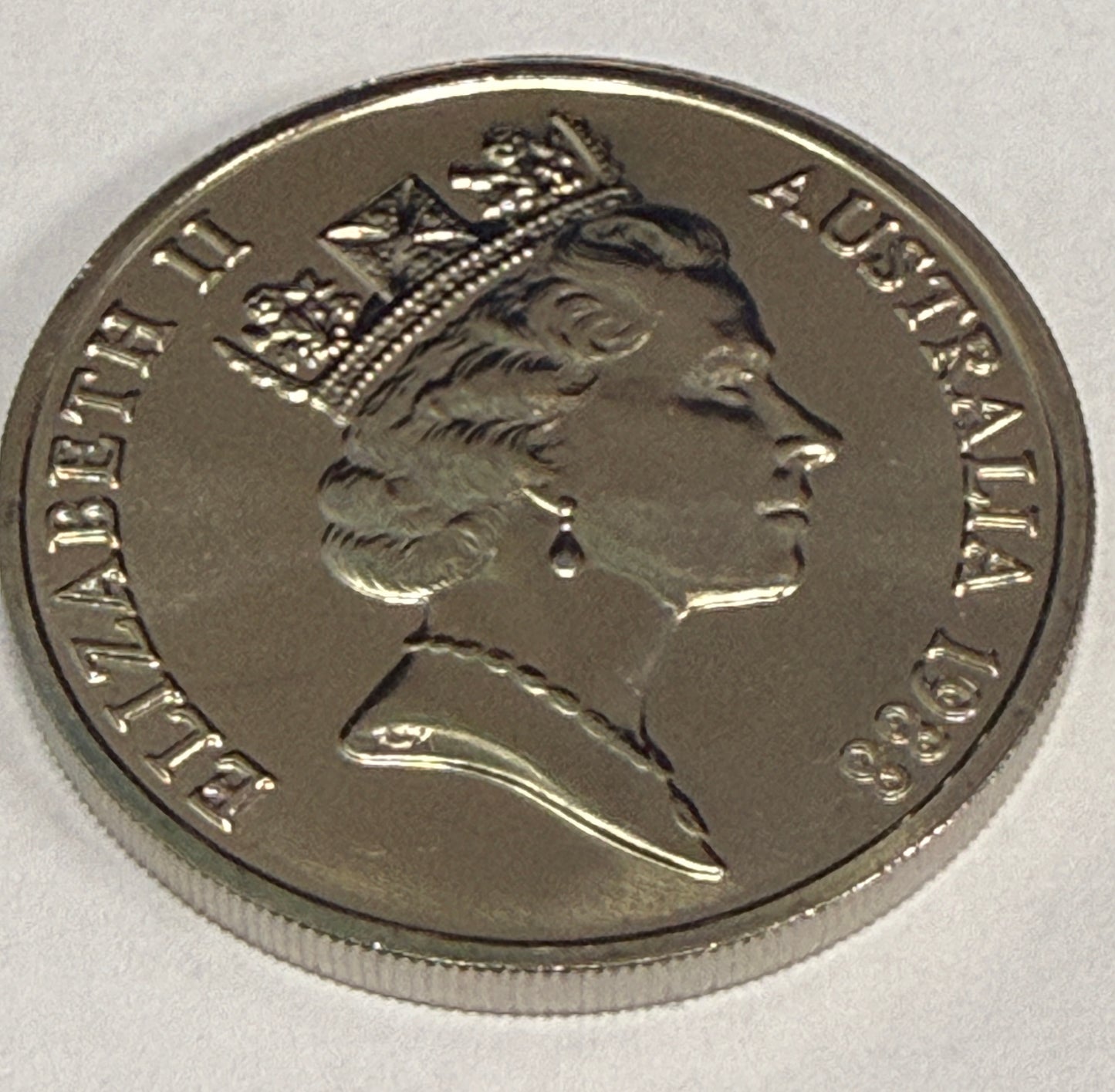 Silver coin with profile of a monarch and 'Elizabeth II Australia 1983' text on a white background