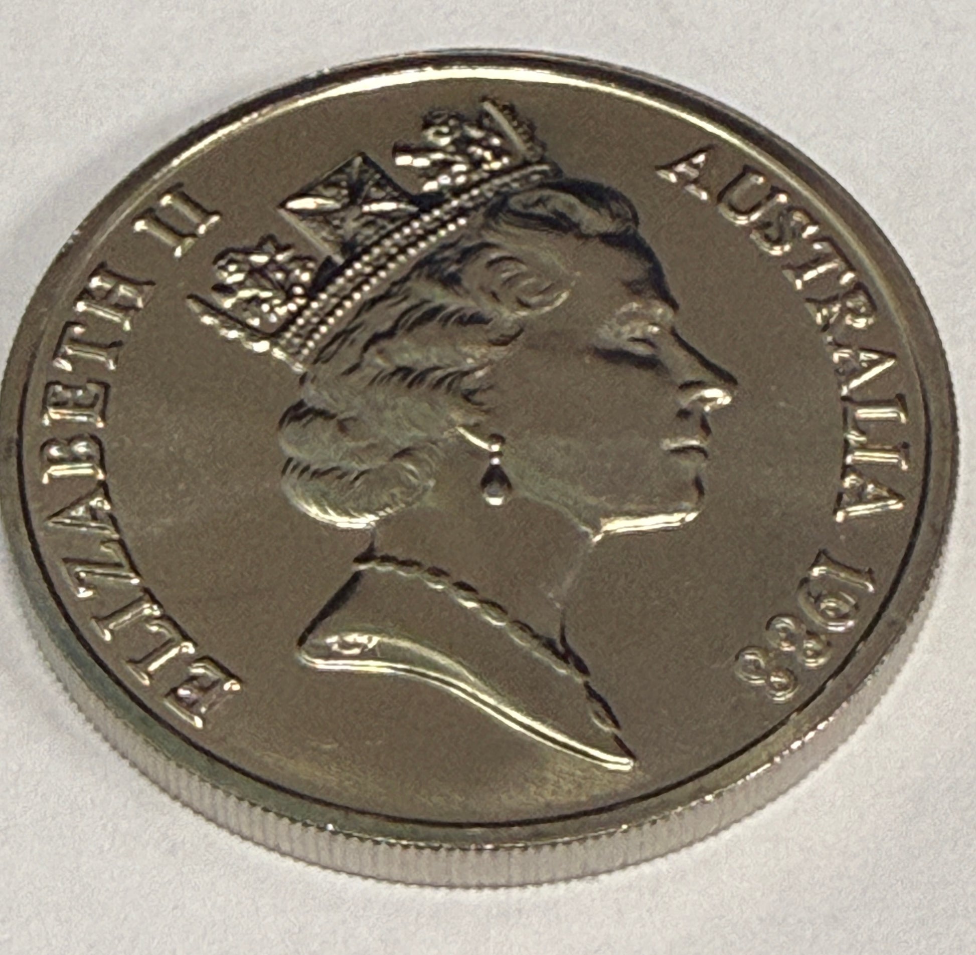 Silver coin with profile of a monarch and 'Elizabeth II Australia 1983' text on a white background