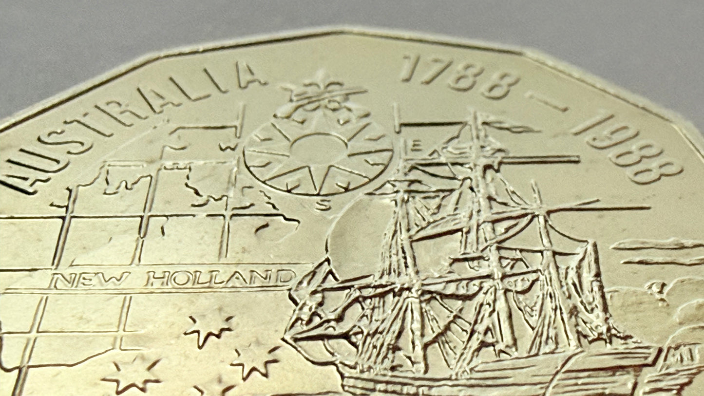 Close-up of a coin commemorating Australia's 1788-1988 anniversary with a ship and map design.