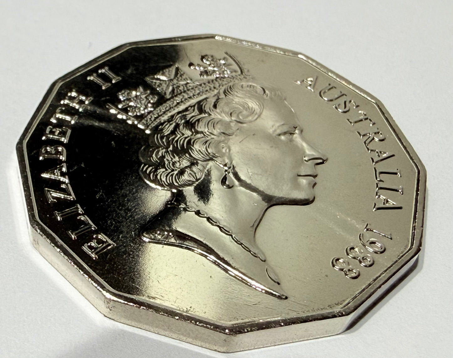 Silver coin with a profile of a queen and 'Elizabeth II' and 'Australia' text on a white background