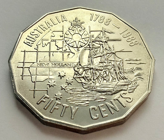Australian fifty cents coin with ship and text on a gray background