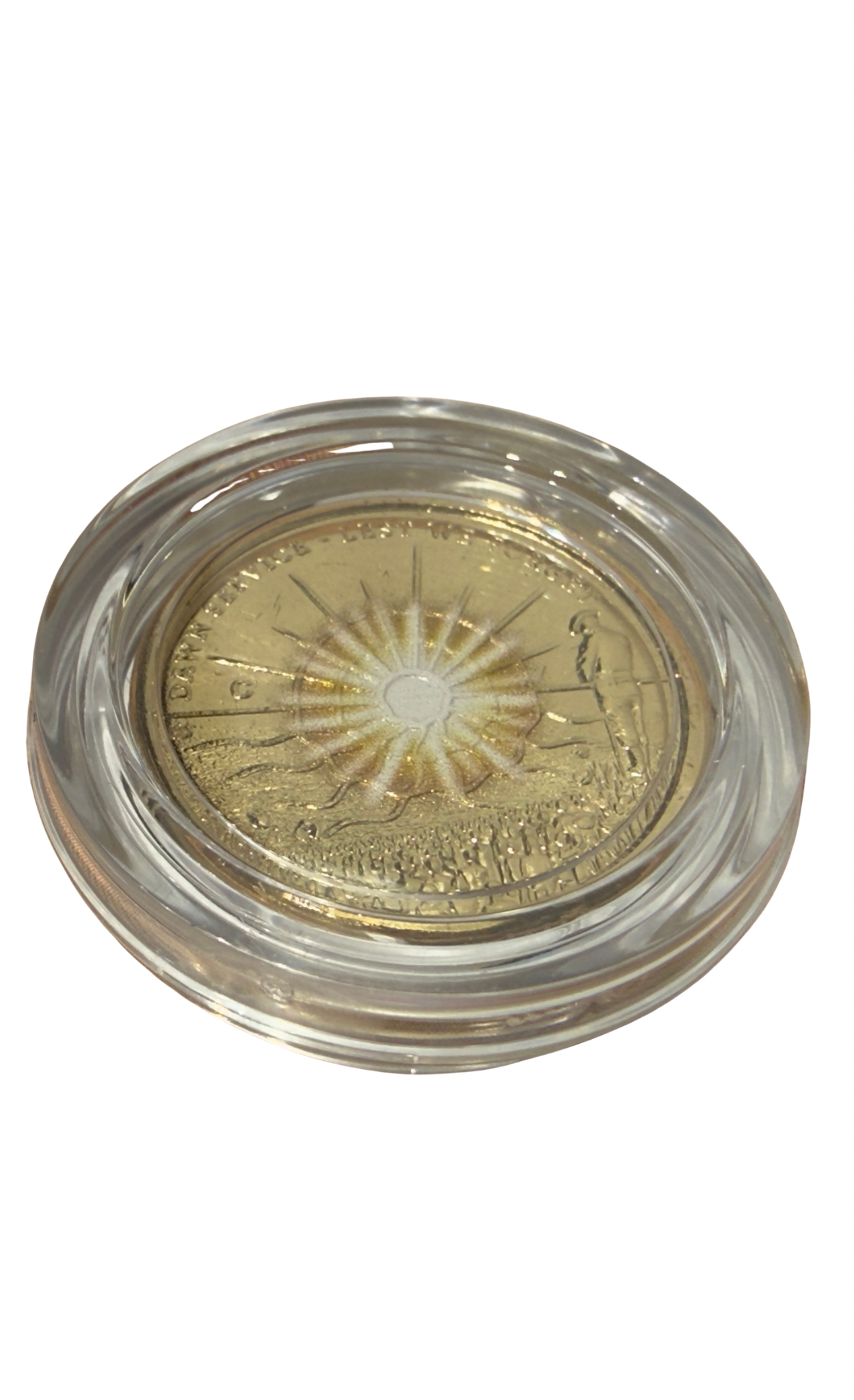 Gold coin in a clear protective case on a white background